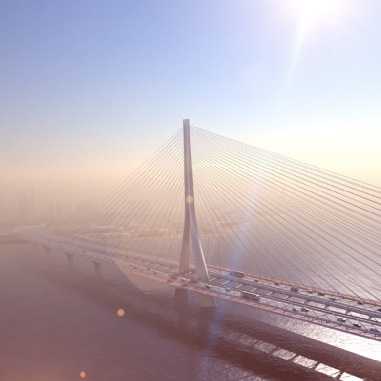 Modern one-pole bridge on a sunny day, cars crossing, city in background.