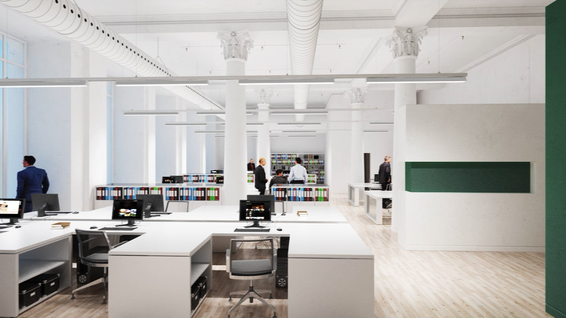 People in an open, clean office with modern luminaires.