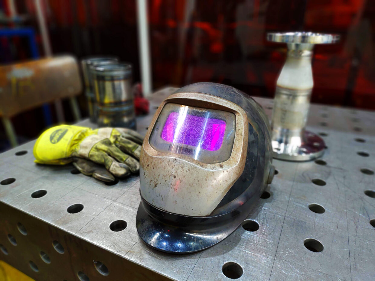Welding goggles and work gloves close-up.