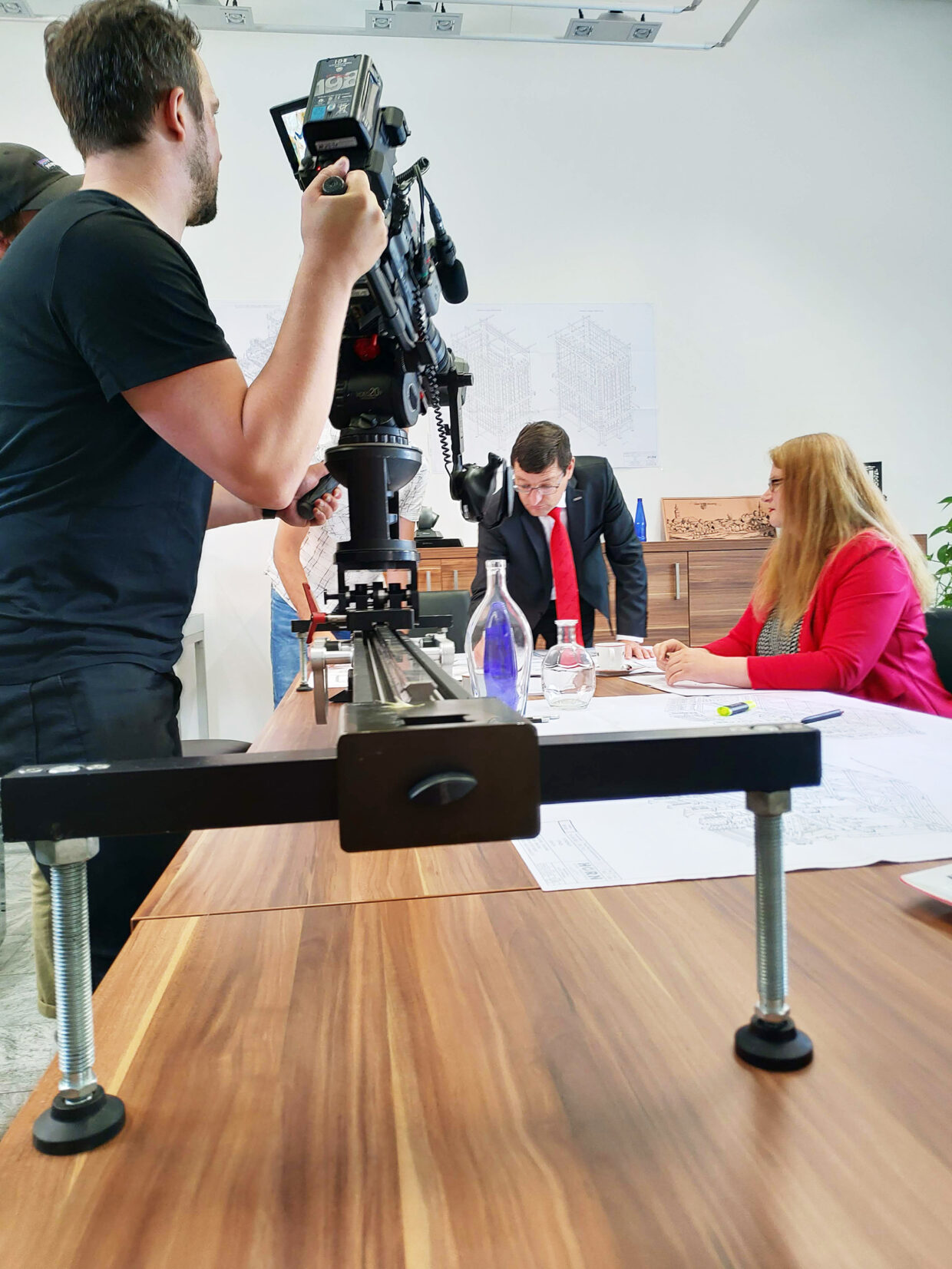 Cameraman films a work-in-progress office szene.