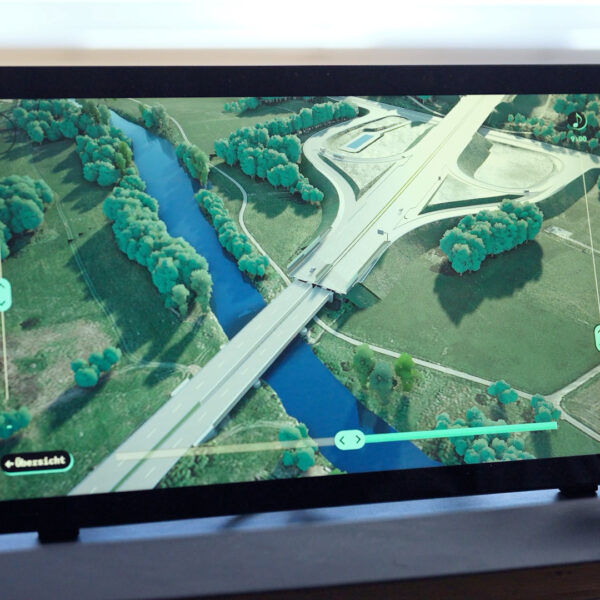 Person is using an interactive application on big touch-screen monitor.